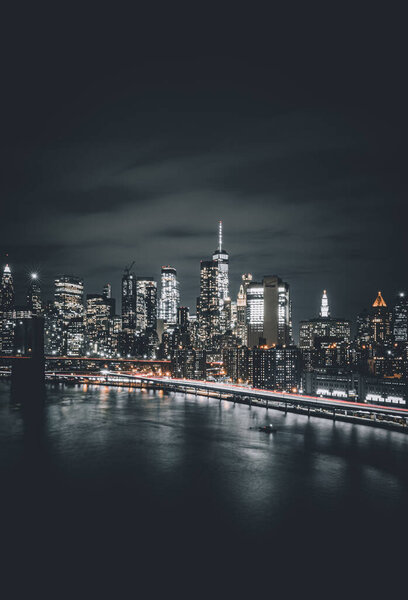 Manhattan night skyline panorama with Brooklyn Bridge and Manhattan Bridge in Manhattan, New York, USA