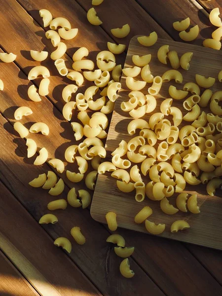 Yellow Macaroni Pasta Wooden Board Background — Stock Photo, Image