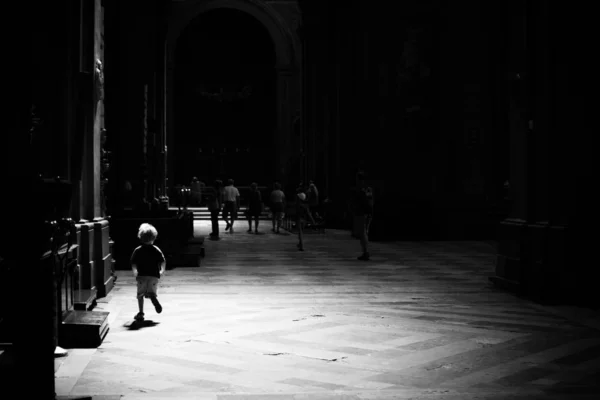 Uma criança correndo em uma nave da igreja, preto e branco — Fotografia de Stock