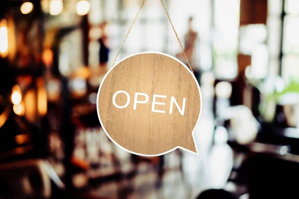 A business sign that says Open on cafe or restaurant hang on door at entrance. Vintage color tone style. — Stock Photo, Image