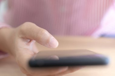 Woman hand use smartphone to do work business, social network, communication in public.