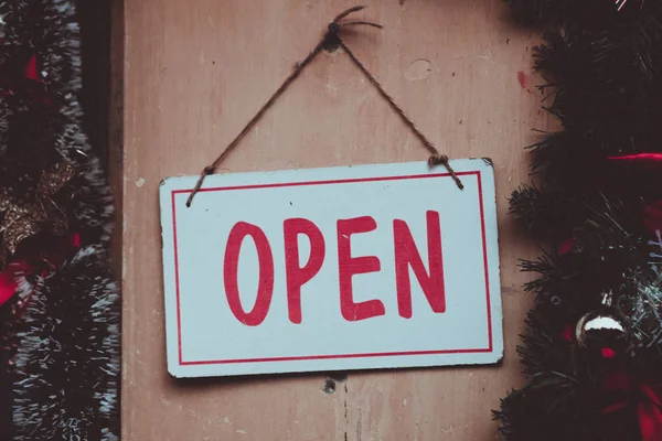 A business sign that says Open on cafe or restaurant hang on door at entrance. — Stock Photo, Image