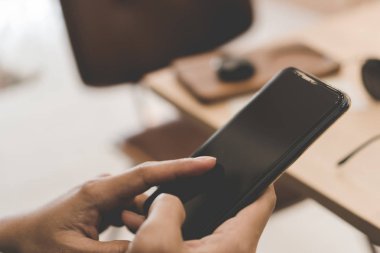 Woman hand use smartphone to do work business, social network, communication in public.