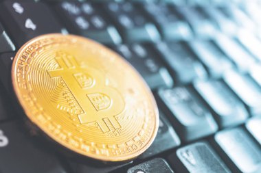 Bir bitcoins sikkesi, bilgisayardaki veya klavyedeki dijital gelecek parasını kopyalanmış arka plan olarak temsil eder. Kripto para birimi finans teknolojisi.