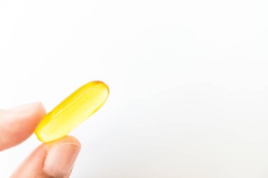 Top view of alternative organic medicine or herbal viatmin supplement capsule tablet on woman hand with copyspace background. Concept of healthy eating.