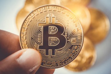 Hand hold a symbol of Bitcoins as digital money cryptocurrency.