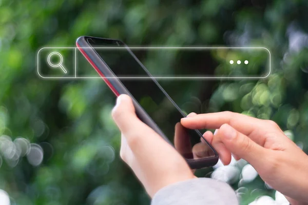 People hand using mobile phone or smartphone searching for information in internet online society web with search box icon and copyspace.