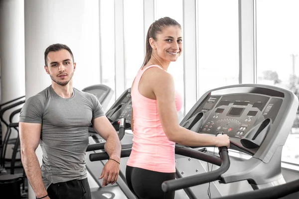 Treadmill walk with personal trainer. — Stock Photo, Image