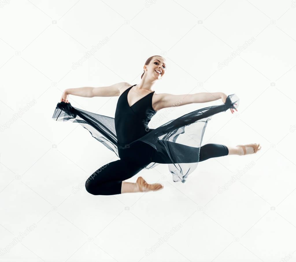 Elegant ballerina jump in ballet hall