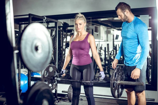 Trap bar deadlift woman with personal trainer — Stock Photo, Image