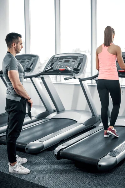 Personal Fitness Trainer Watching His Private Client While Walking Treadmill — Stock Photo, Image