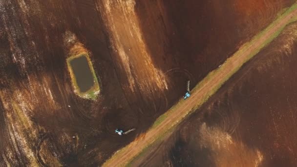Plowed field. The tractor works on the field with a plow. Drone is circling — Αρχείο Βίντεο