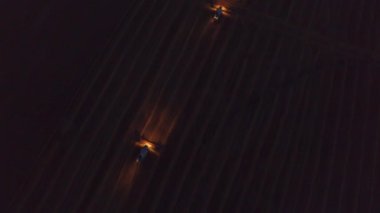 Combine Harvester Working at Night in the Dark During the Summer Harvest