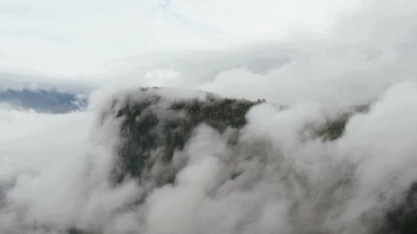 Aerial view drone footage of flowing fog waves on mountain autumn forest. — Stockvideo