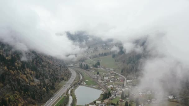 Mountain city in morning fog aerial landscape. Drone view misty haze, highlands landscape. — Stock Video