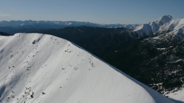 Aéreo: drone voando acima do pico da montanha de neve . — Vídeo de Stock