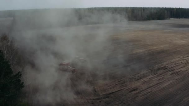 Αεροφωτογραφία κινούμενου ελκυστήρα με σκόνη ανύψωσης άροτρου που προετοιμάζει το πεδίο για σπορά — Αρχείο Βίντεο