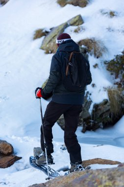 Ransol, Andorra: 10 Dic 2019: Andorra 'daki Pireneler' de kışın inanılmaz güneşli bir günde kış gezisinde kar ayakkabısı pratiği yapan genç erkekler.