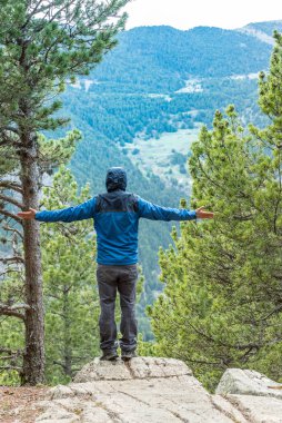 Canillo, Andorra: 2 Mayıs 2020: Andorra Pireneleri 'ndeki dağlara bakan genç adam.