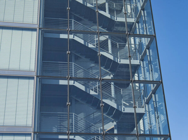 An open stairwell in a high-rise building behind a glass facade