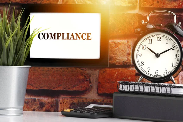 Compliance Text Alarm Clock Books Vase Brick Background Business Quotes — Stock Photo, Image