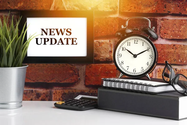 News Update Text Alarm Clock Books Vase Brick Background Business — Stock Photo, Image