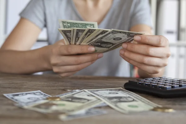 Close up of woman with calculator counting money — Stock Photo, Image
