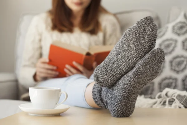 Mujer joven leyendo libro en casa — Foto de Stock