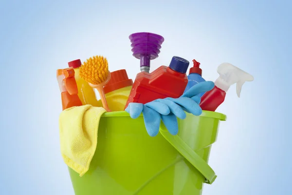Plastic bucket with cleaning supplies on blue background — Stock Photo, Image