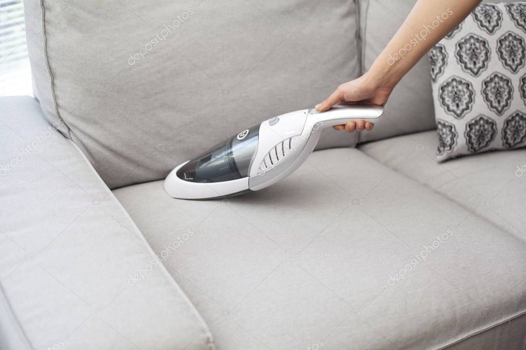 Woman With Handheld Vacuum Cleaning On Sofa Stock Photo Seb Ra Woman With Handheld Vacuum Cleaning On Sofa Stock Photo
