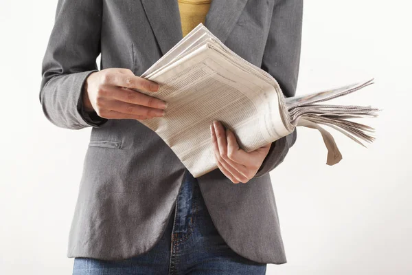 Young woman reading newspaper on white background — Stock Photo, Image