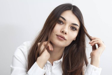 Portrait of young woman on gray background