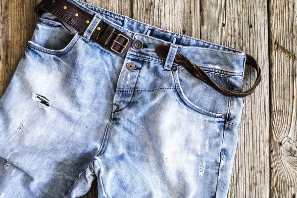 Blue jeans on wooden background — Stock Photo, Image
