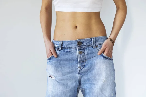 Close up view of woman belly and jeans — Stock Photo, Image