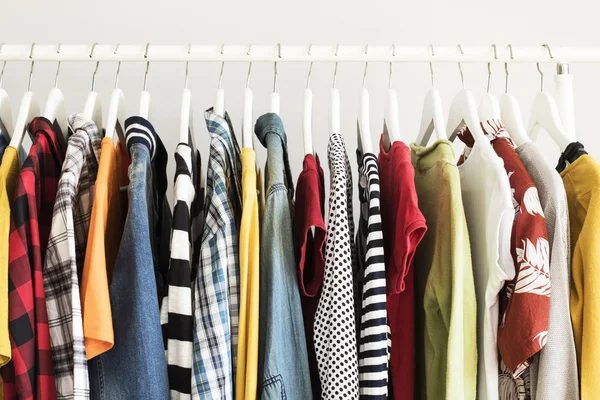 Collection of clothes hanging on rack — Stock Photo, Image