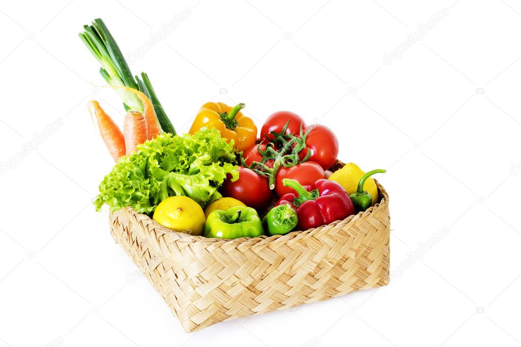 Vegetables in basket on white background