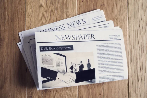 Newspaper on wooden table — Stock Photo, Image