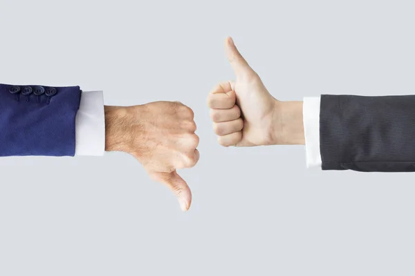 Hands making thumbs up and down — Stock Photo, Image