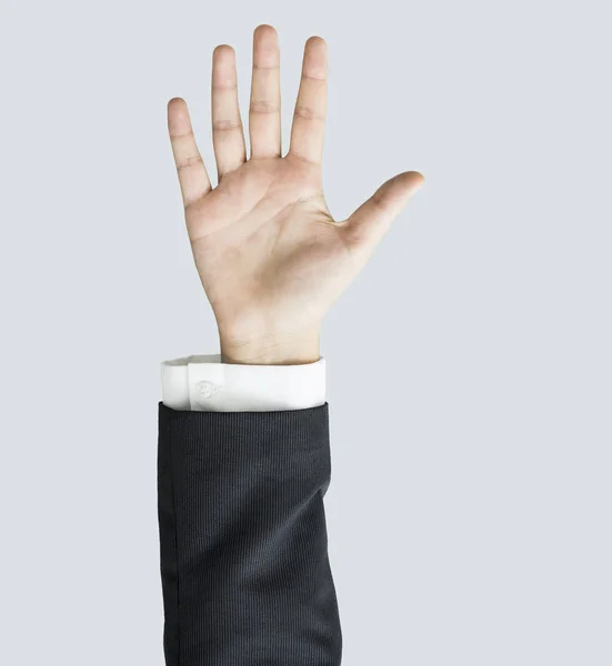 Mulher mão levantada no fundo cinza — Fotografia de Stock