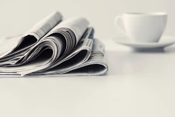 Newspaper with a cup of coffee on table — Stock Photo, Image