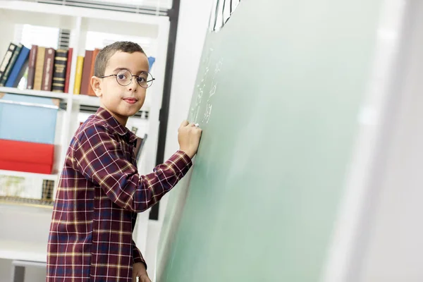 School child writing blackboard