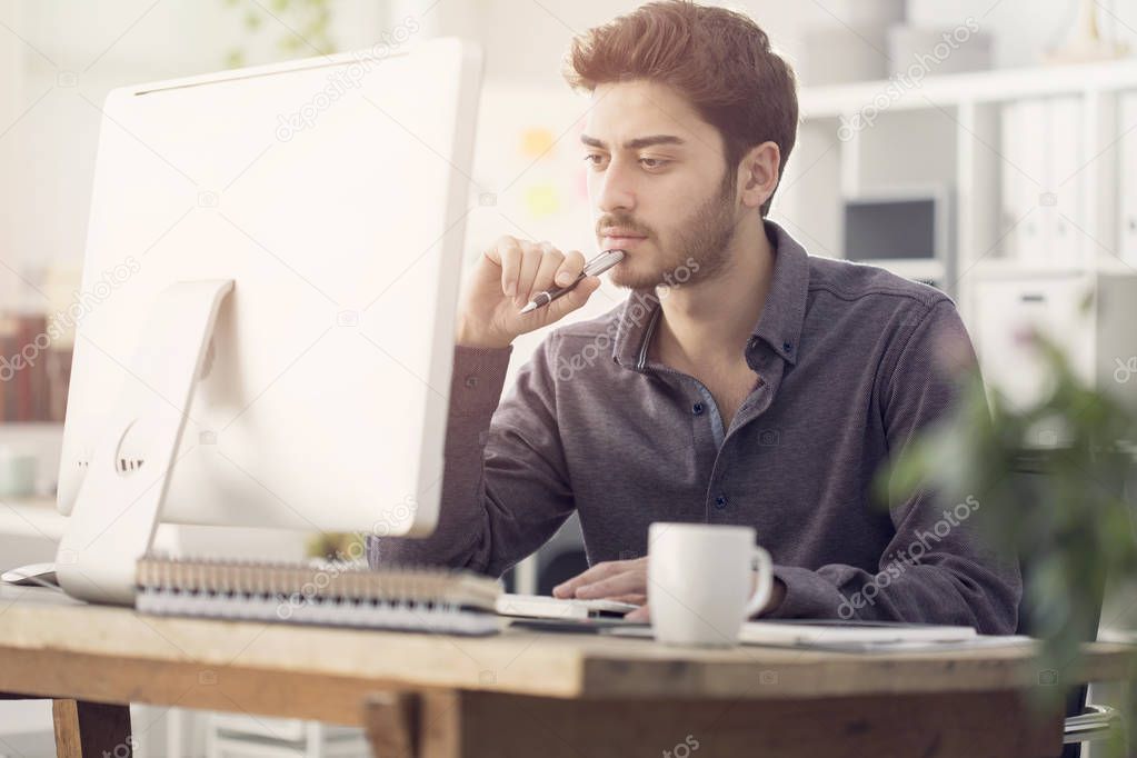 Young man works on his laptop