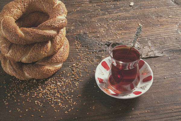 Turkish bagel and tea glass on wooden background