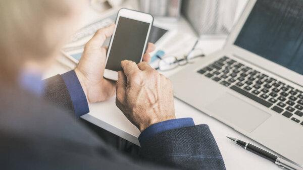 Businessman using mobile phone in office
