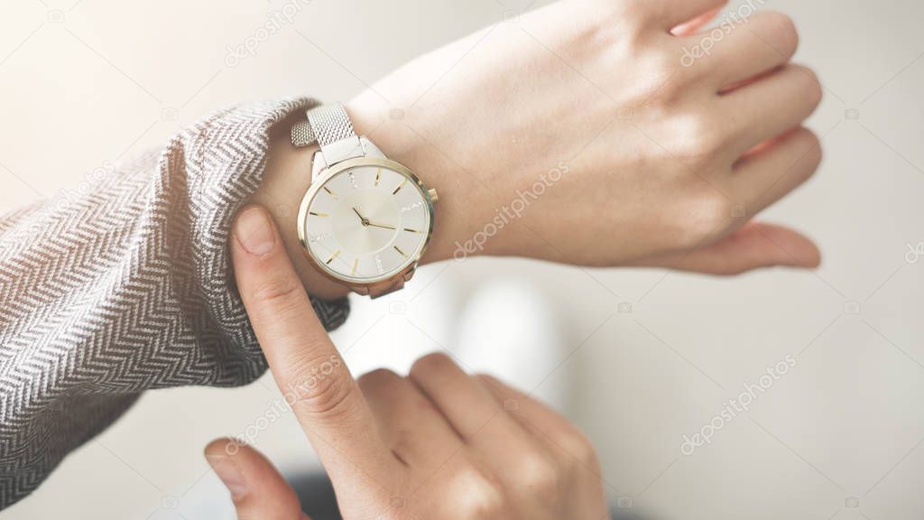 Woman checking time her watch