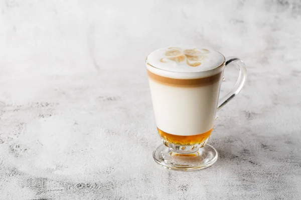 Coffee with Irish whiskey and whipped cream in glass isolated on bright marble background. Overhead view, copy space. Advertising for cafe menu. Coffee shop menu. Horizontal photo.