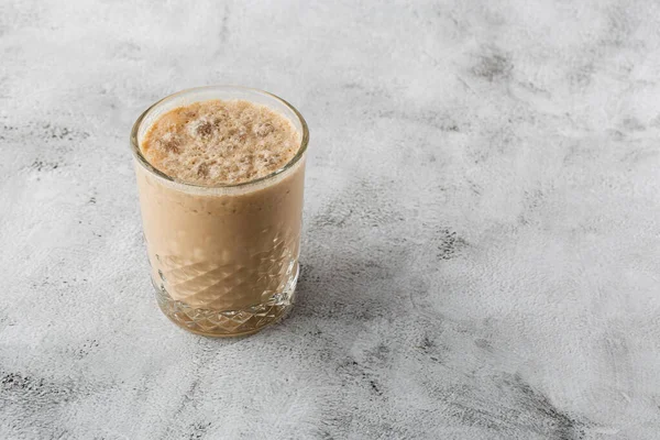 Glass with cold brew coffee and milk isolated on bright marble background. Overhead view, copy space. Advertising for cafe menu. Coffee shop menu. Horizontal photo.