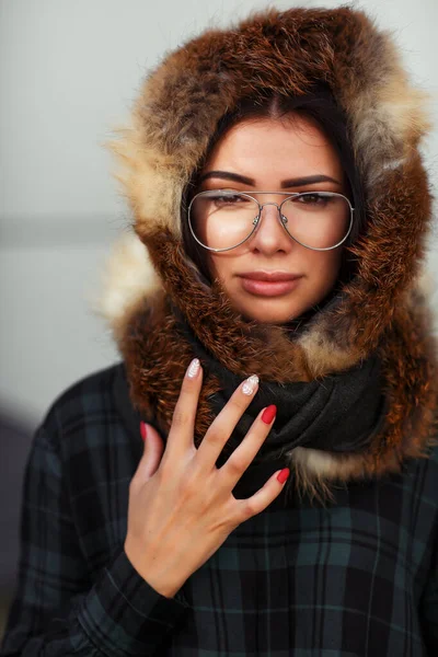 Outdoor close up fashion portrait of young beautiful confident woman wearing trendy shirt, brown scarf and sunglasses Beautiful woman in luxury fur shawl. Advertising for sunglasses shop. Copy space.