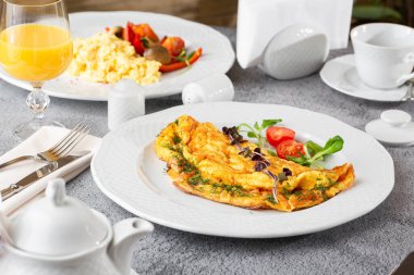 Peynirli omlet, vişneli domates ve beyaz mermer arka planda izole edilmiş ekşi ekmek. Ev yapımı yemek. Lezzetli bir kahvaltı. Seçici odaklanma. Hotizontal fotoğraf.