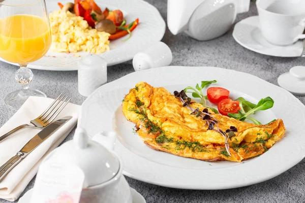 Peynirli omlet, vişneli domates ve beyaz mermer arka planda izole edilmiş ekşi ekmek. Ev yapımı yemek. Lezzetli bir kahvaltı. Seçici odaklanma. Hotizontal fotoğraf.